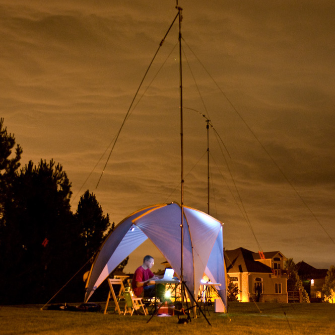 A Radio Operator in a field entering a HF Contest at night.